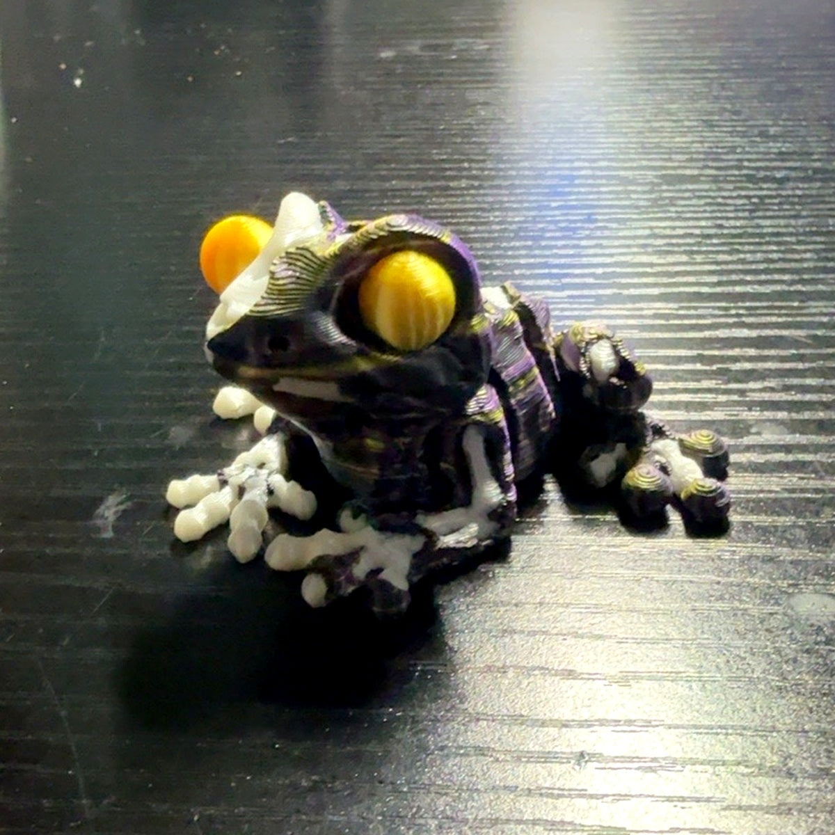 ZombieFrog articulated zombie frog in black with purple and gold swirl color scheme